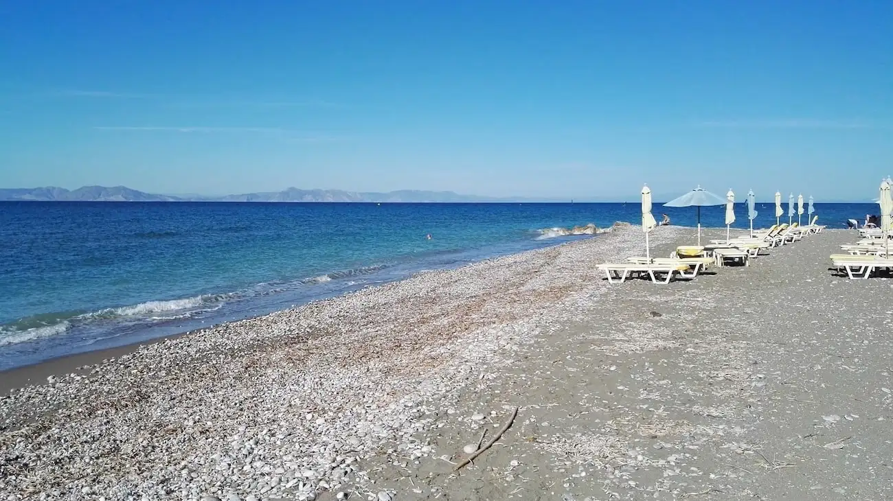 Kite gliders along the open horizon of Theologos beach